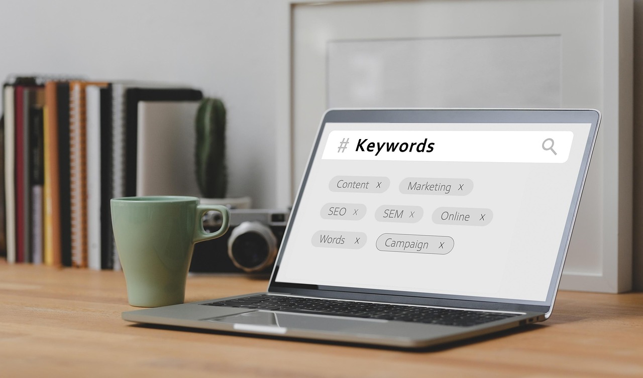 SEO keyword research concept with laptop displaying keywords like content, SEO, and marketing