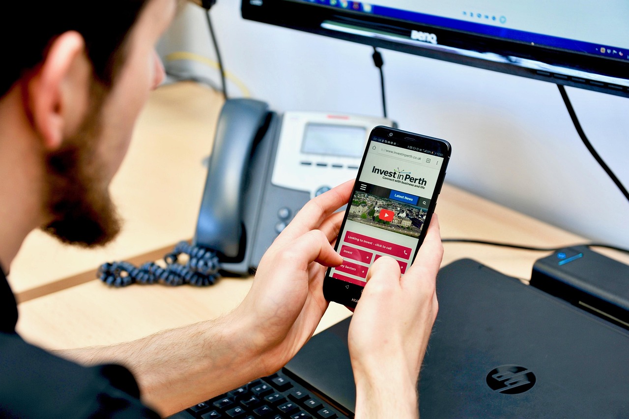 User browsing a responsive website on a smartphone — illustrating mobile-first, responsive web design and SEO optimisation for businesses in Singapore.